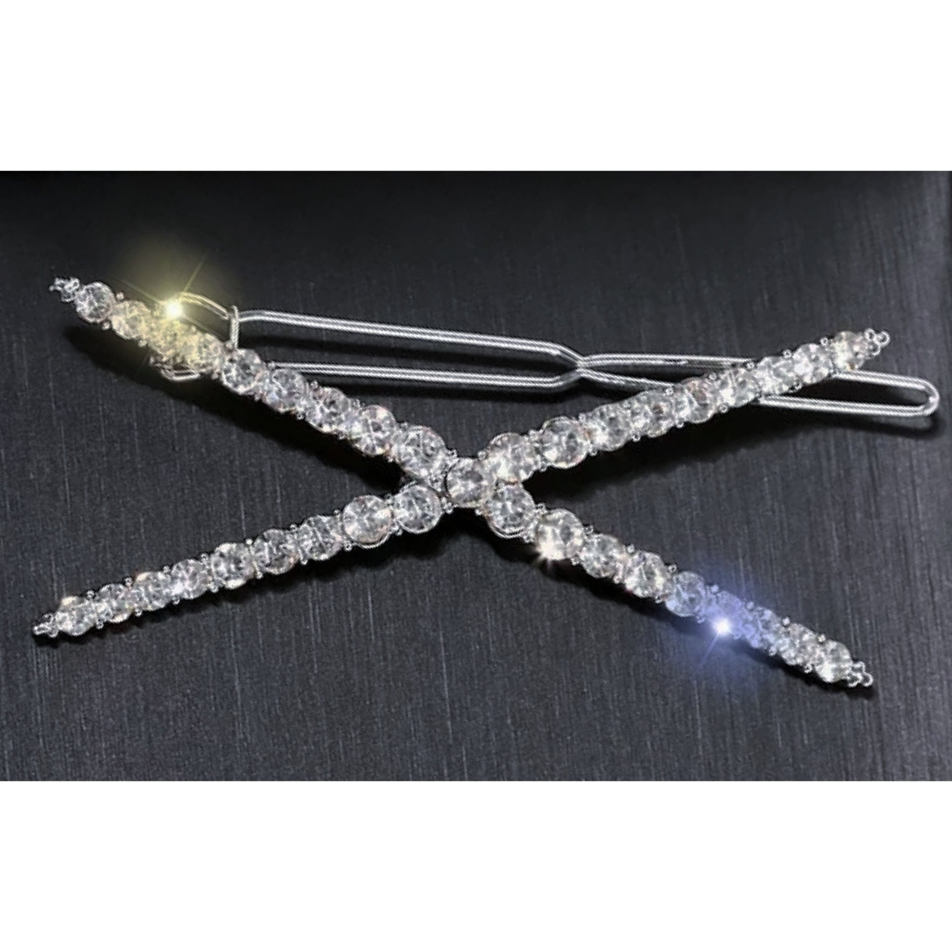Silver X shape rhinestone hair clip.
